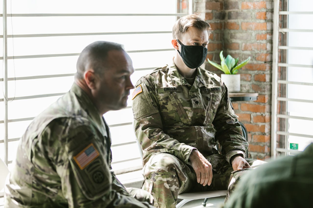 Two military personnel in a therapy session focused on mental health support and recovery.